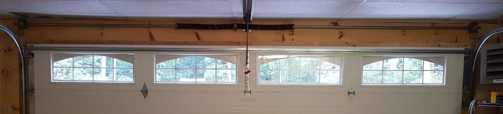 Interior view of newly installed insulated sectional garage door with windows in Darien, IL home